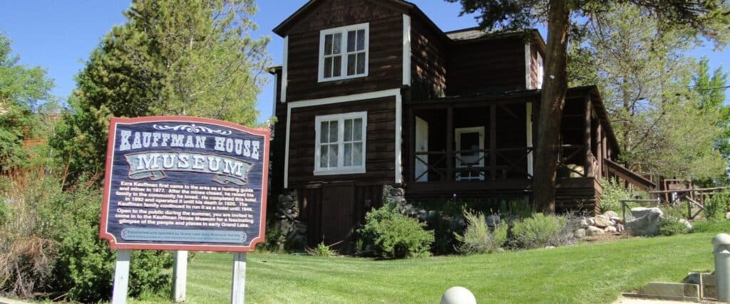 Exterior of the historic Kauffman House Museum with its sign out front in Grand Lake, Colorado.