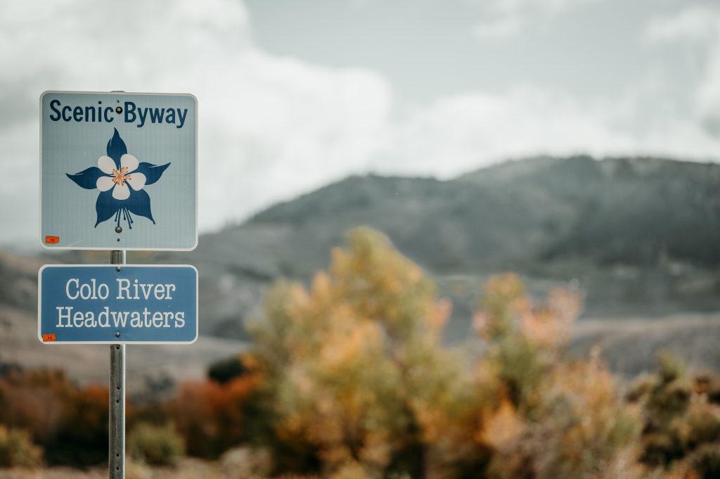 Scenic Byway sign for Colorado River Headwaters with mountains in the background.