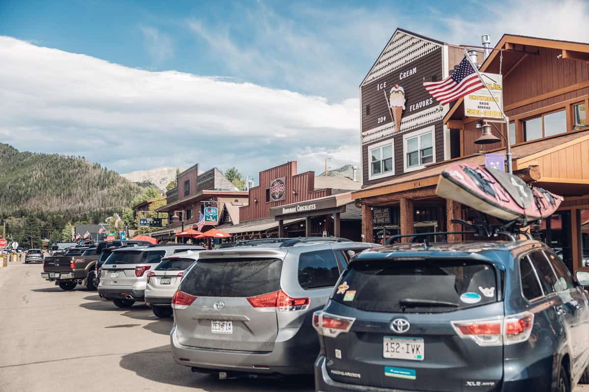 Downtown Grand Lake with parked cars and storefronts on a sunny day.