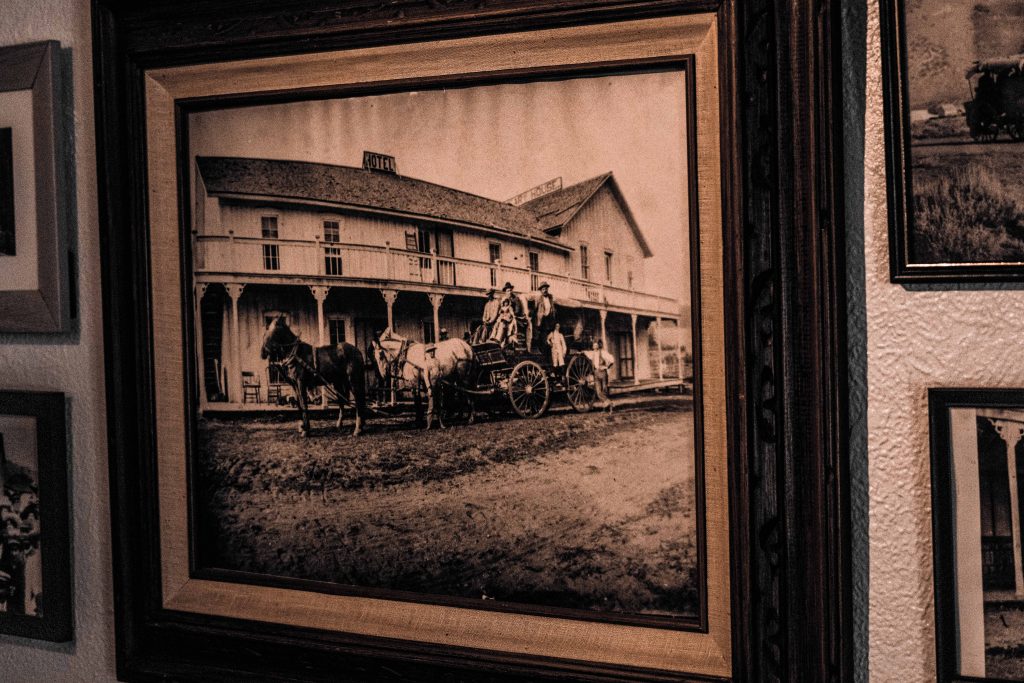 Historic photo of Dean’s Public House with horse-drawn carriage.